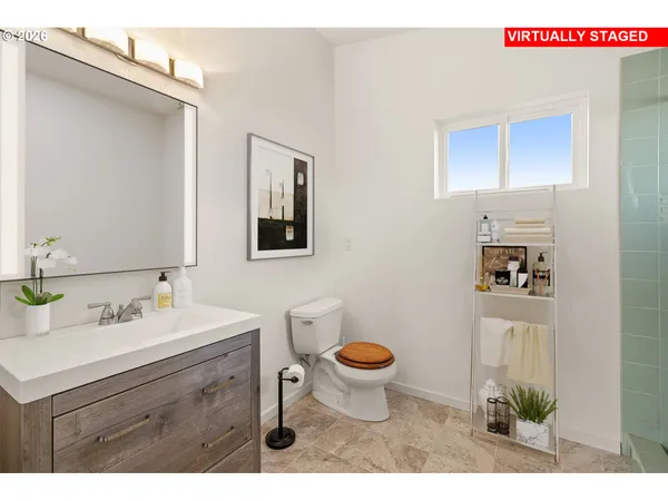a bathroom with a sink mirror vanity and toilet