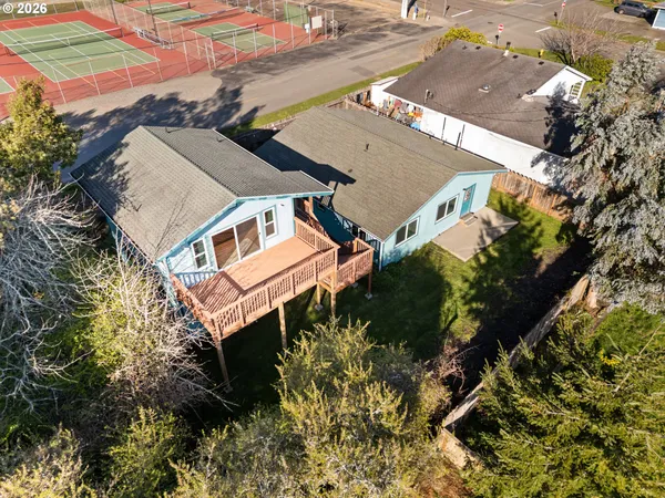 an aerial view of a house with a yard and garden