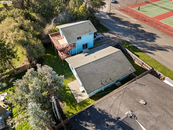 an aerial view of a house with a yard