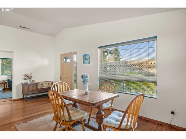 a view of a dining room with furniture window and wooden floor