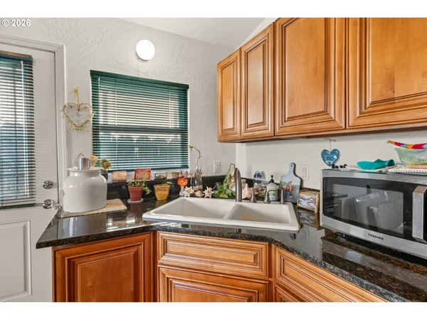 a kitchen with stainless steel appliances granite countertop a sink stove and cabinets