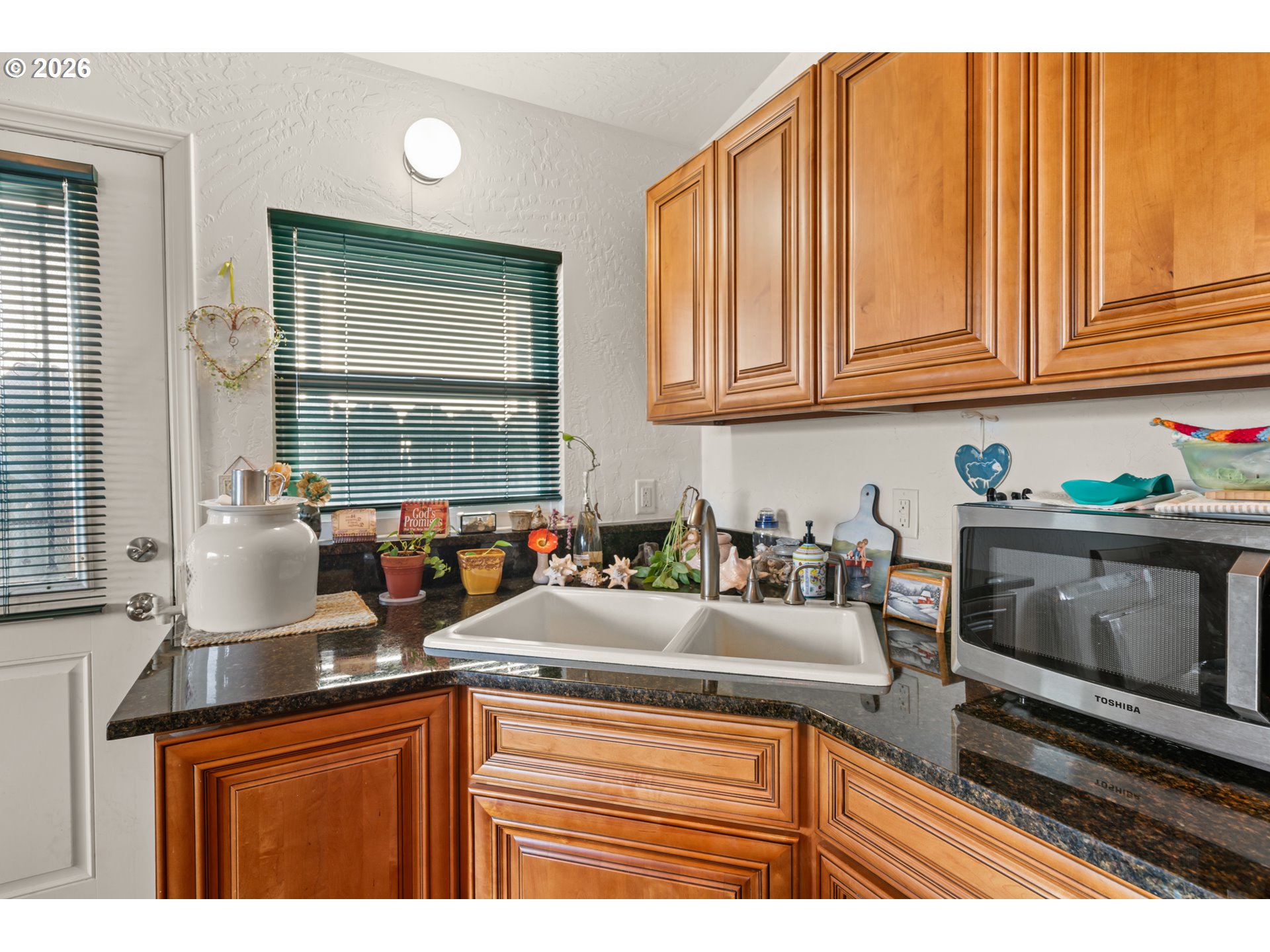1115 Ransom Avenue Brookings, OR 97415 - Photo 8 of 32 a kitchen with stainless steel appliances granite countertop a sink stove and cabinets