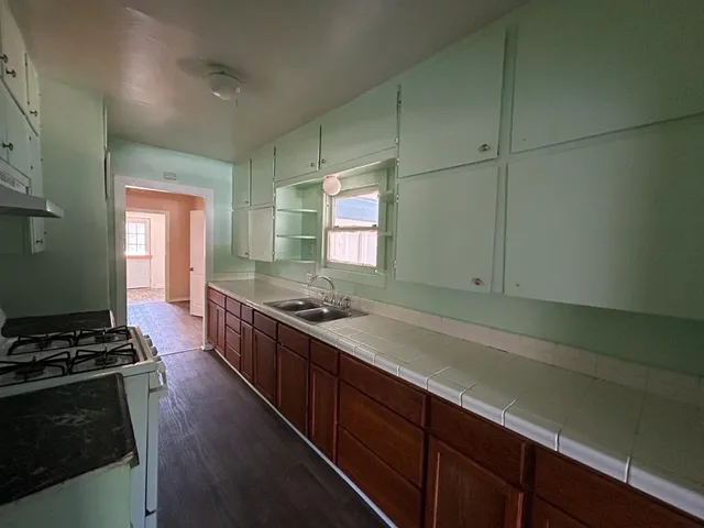 a kitchen with stainless steel appliances granite countertop a stove a sink and a refrigerator