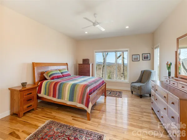 a bedroom with a large bed and a chandelier