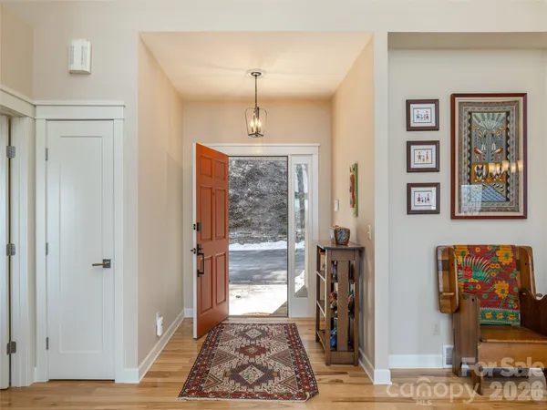 a very nice looking room with many windows and closet