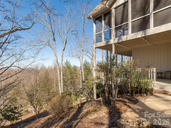 a view of a house with yard and sitting area