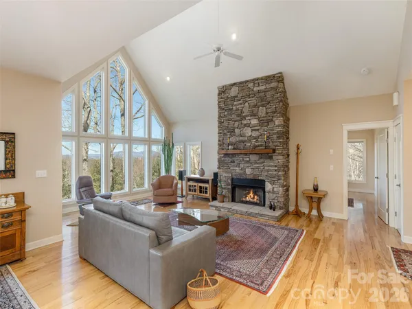 a living room with furniture large window and a fireplace