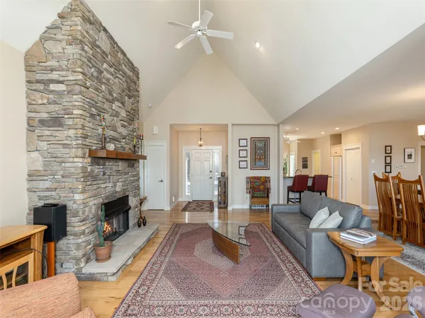 a living room with furniture a fireplace and a table