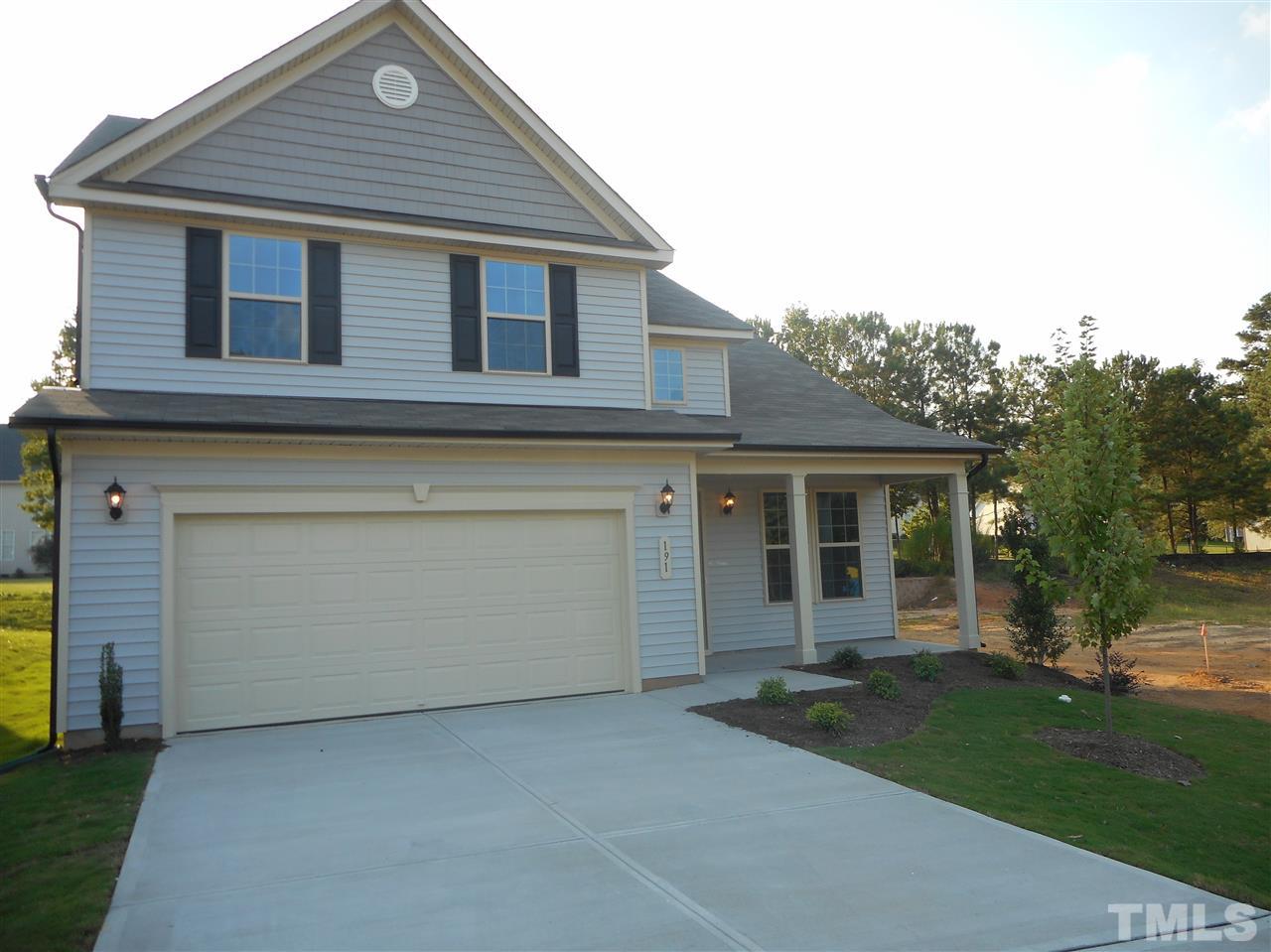 1509 Bentons Ridge Drive Raleigh, NC 27610 - Photo 2 of 23 a front view of a house with a garden and yard