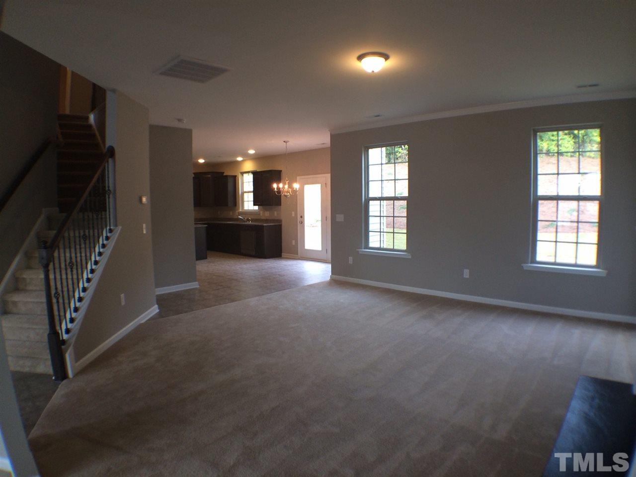1509 Bentons Ridge Drive Raleigh, NC 27610 - Photo 16 of 23 an empty room with windows and fireplace