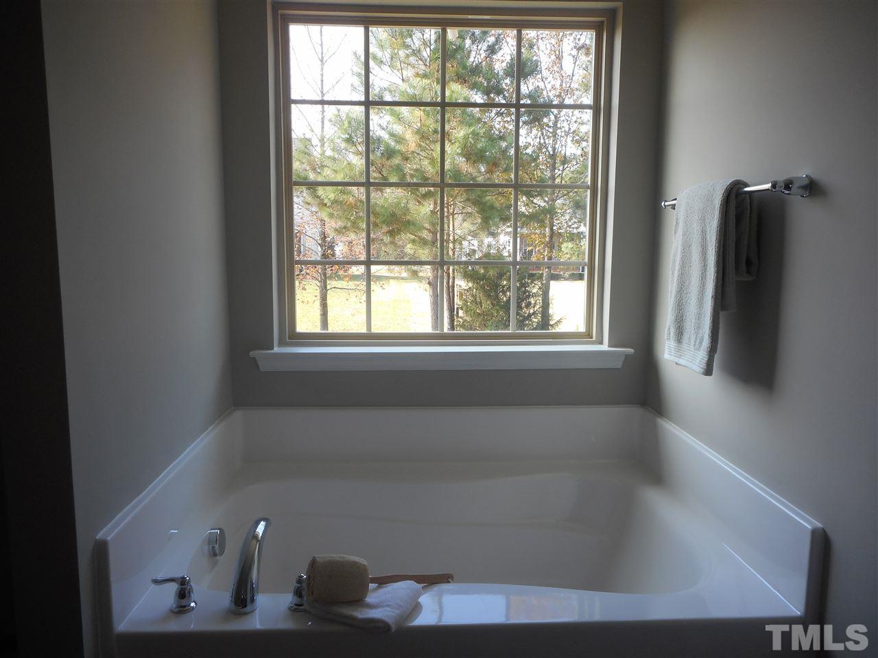 1509 Bentons Ridge Drive Raleigh, NC 27610 - Photo 19 of 23 a bath tub sitting next to a window