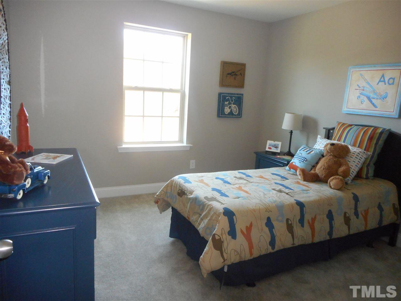 1509 Bentons Ridge Drive Raleigh, NC 27610 - Photo 20 of 23 a bedroom with a bed and a window
