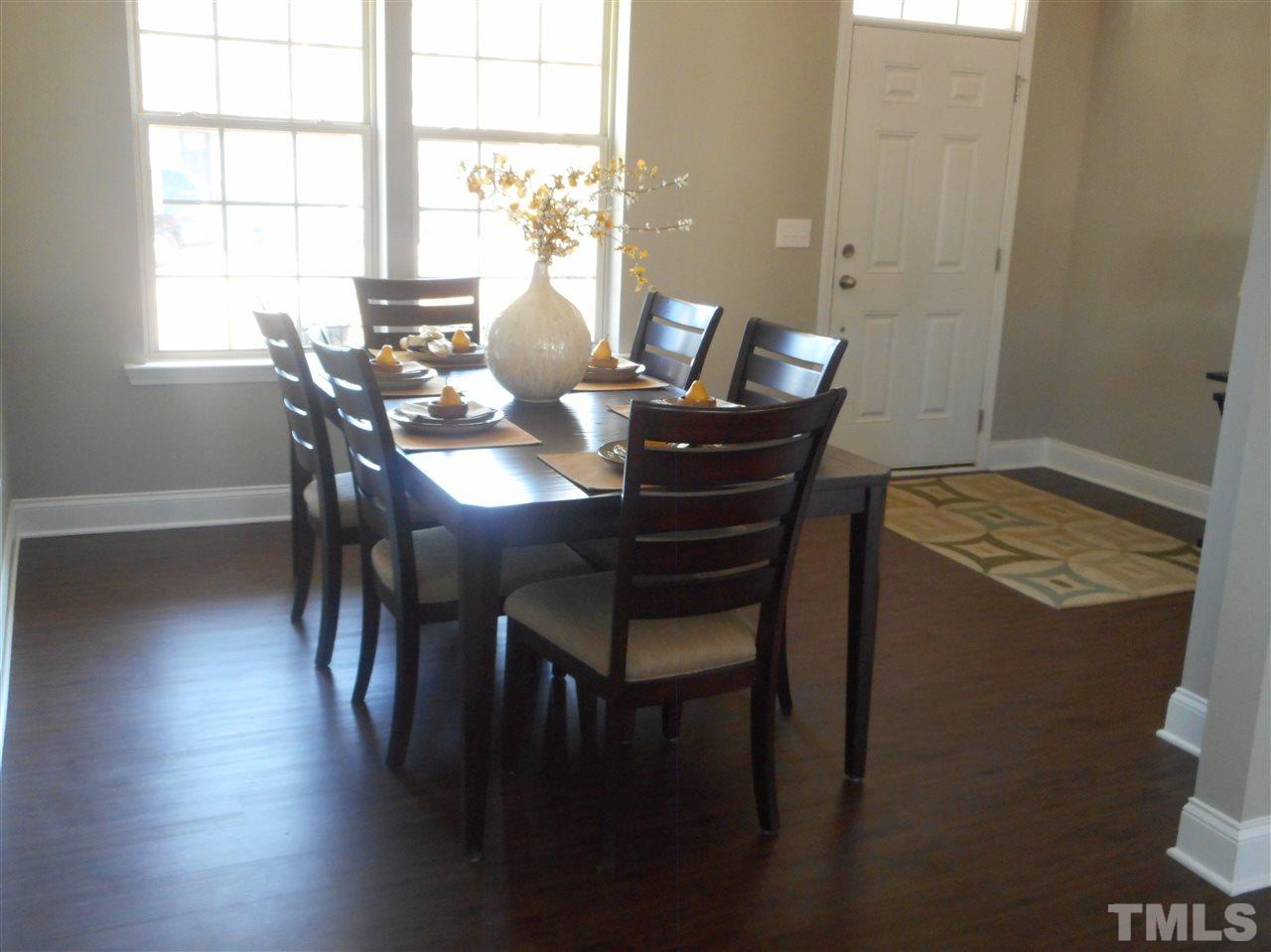 1509 Bentons Ridge Drive Raleigh, NC 27610 - Photo 6 of 23 a view of a dining room with furniture and wooden floor