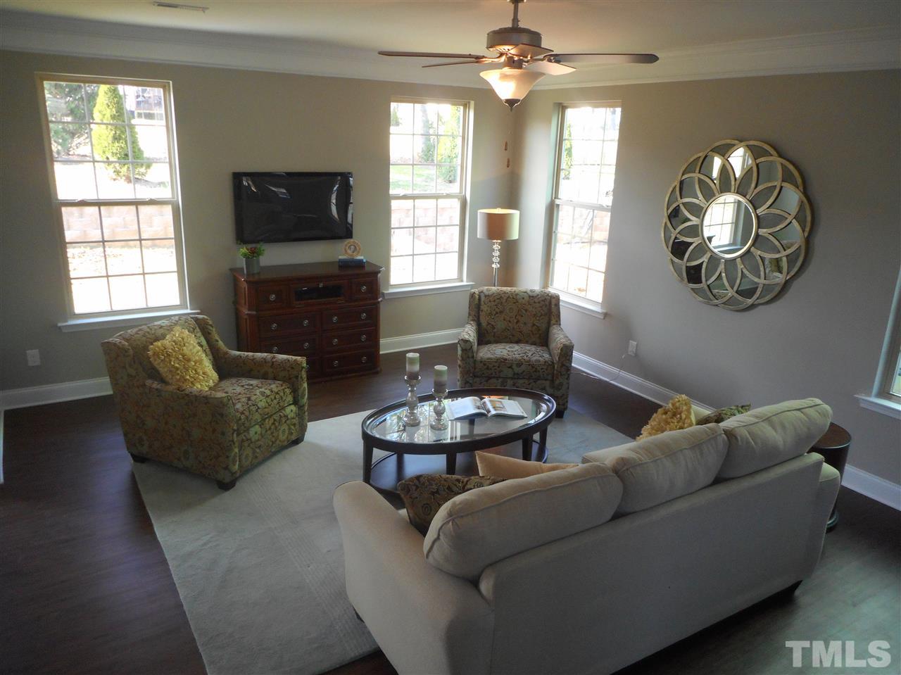 1509 Bentons Ridge Drive Raleigh, NC 27610 - Photo 9 of 23 a living room with furniture a fireplace and a flat screen tv