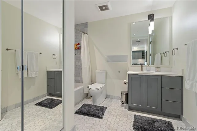 a spacious bathroom with a toilet a sink and shower