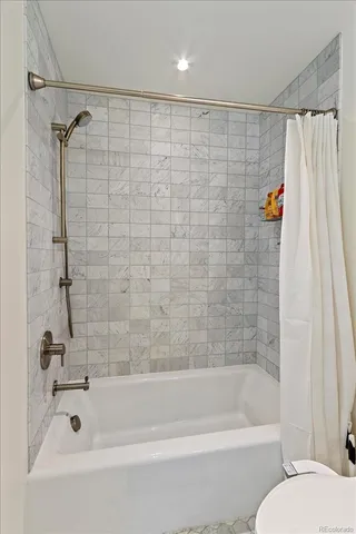 a bathroom with a shower and a bath tub