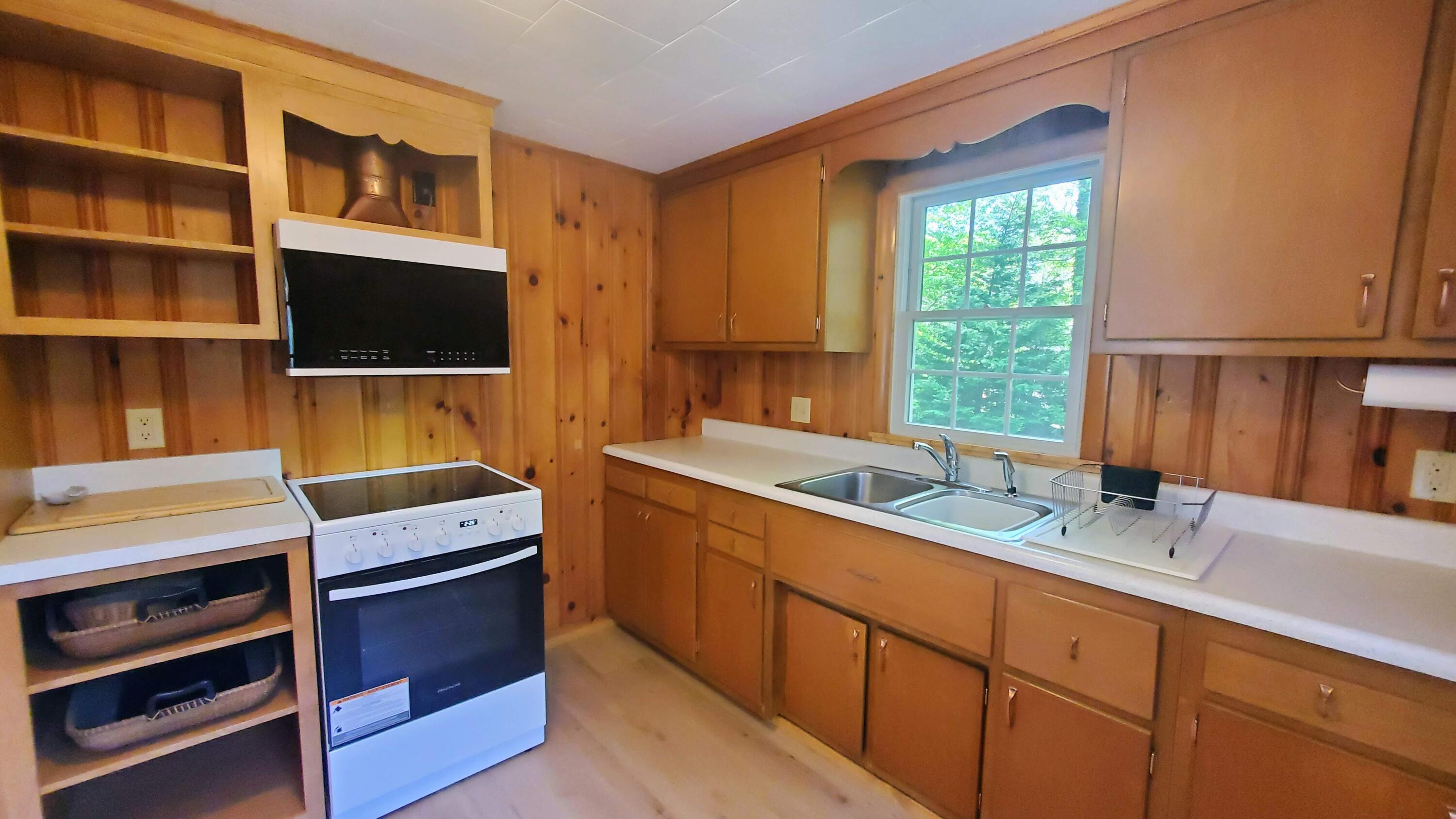 66 Uncle Edwards Road Mashpee, MA 02649 - Photo 6 of 18 a kitchen that has a sink and a stove in it