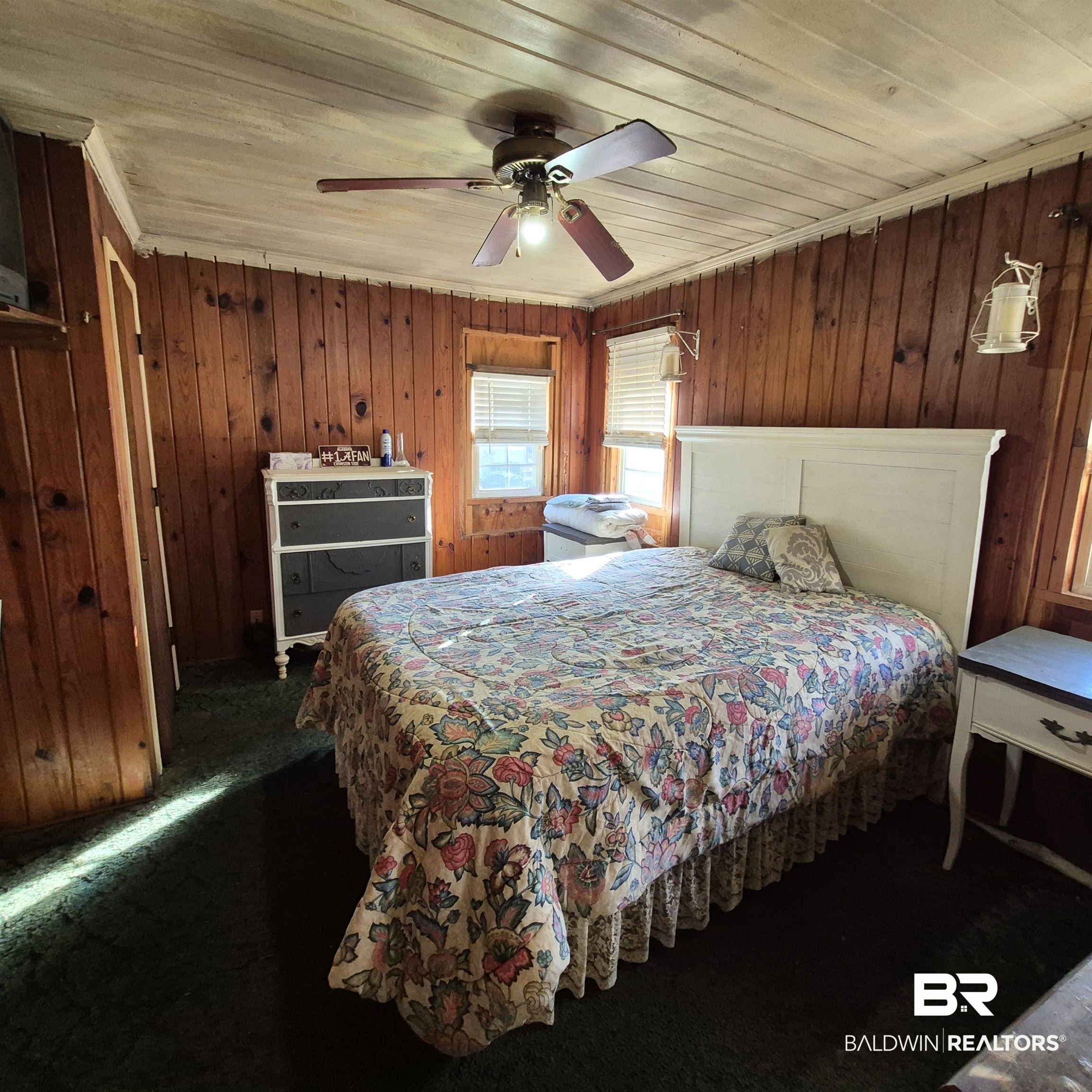 320 Bruner Avenue Evergreen, AL 36401 - Photo 5 of 15 Carpeted bedroom with wooden walls, a ceiling fan, and wooden ceiling