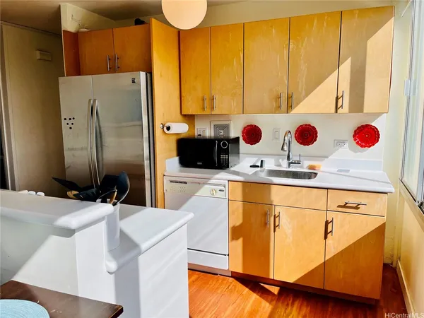 a kitchen with stainless steel appliances kitchen island granite countertop a sink and cabinets