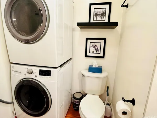 a bathroom with a toilet a sink and a mirror