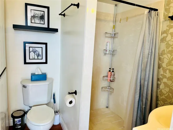 a bathroom with a toilet and a shower