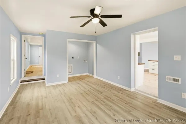 a view of a hallway with wooden floor and closet