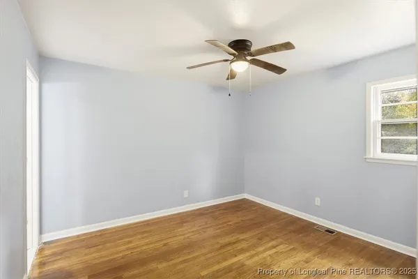 a view of a room with a ceiling fan
