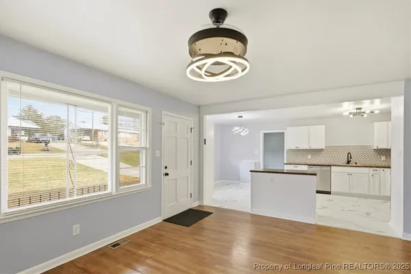 a view of kitchen and wooden floor