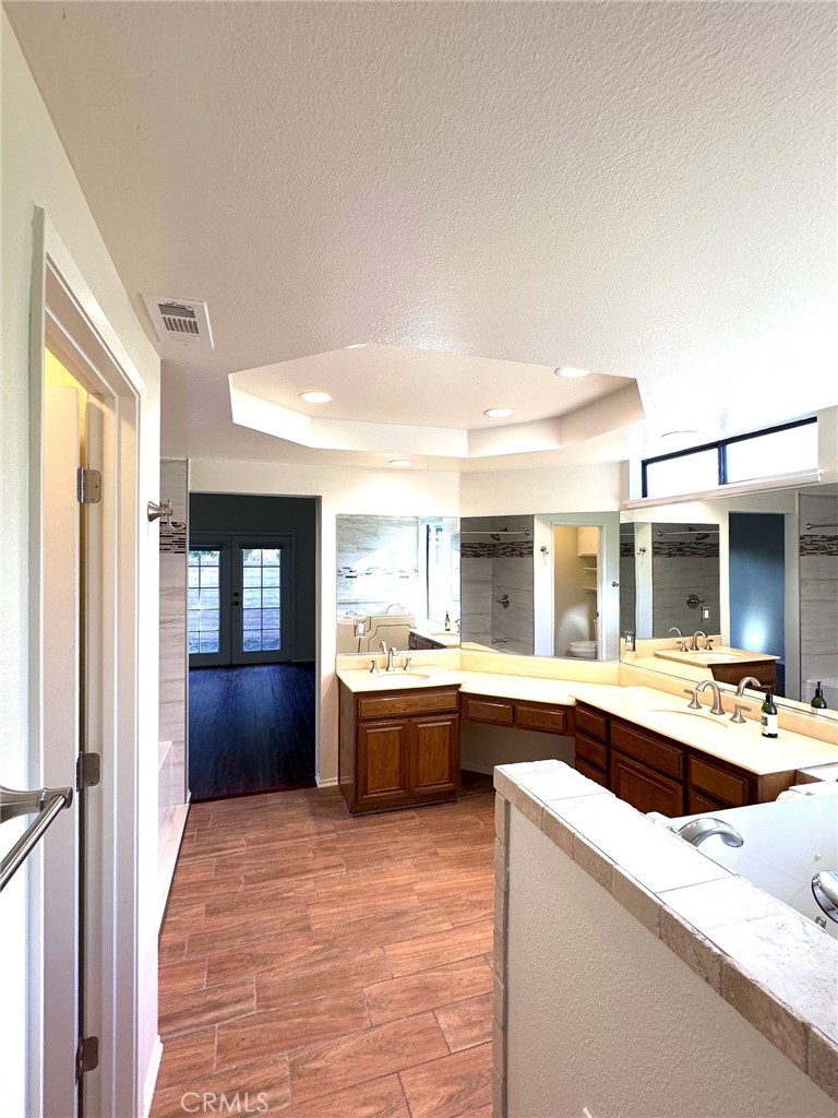183 South Starflower Street Brea, CA 92821 - Photo 22 of 42 a large white kitchen with cabinets