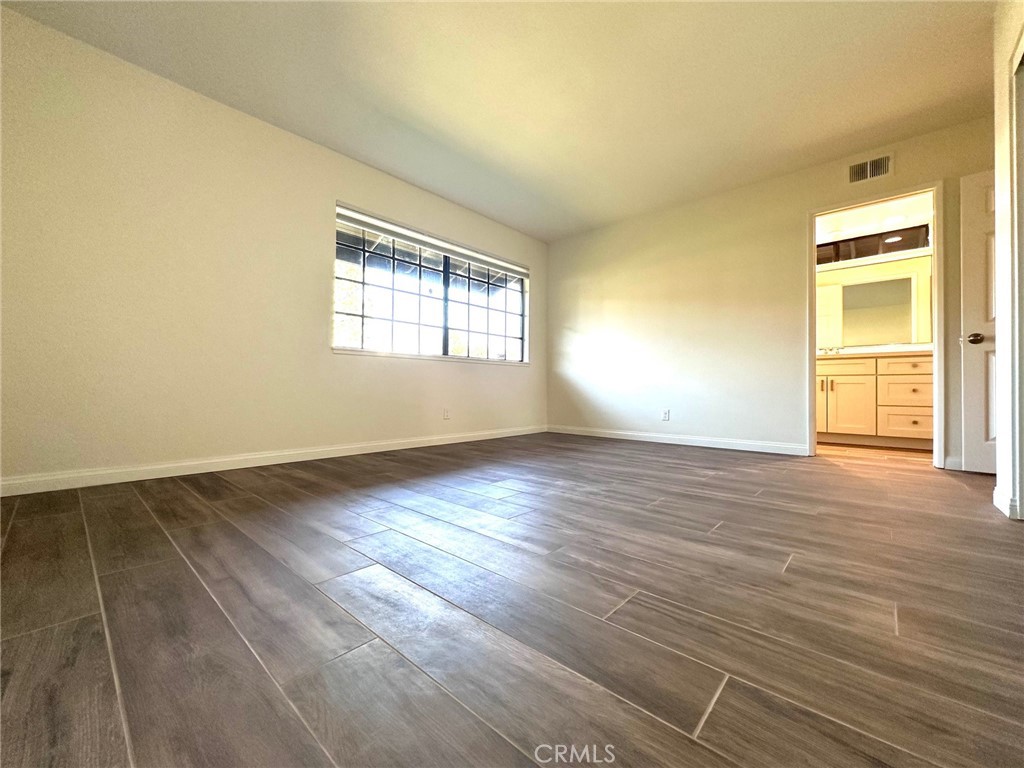 183 South Starflower Street Brea, CA 92821 - Photo 25 of 42 an empty room with wooden floor and windows
