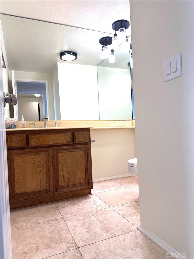 183 South Starflower Street Brea, CA 92821 - Photo 31 of 42 a bathroom with a sink a toilet and mirror