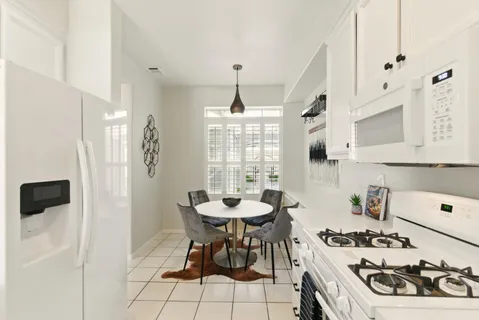 a kitchen with a table and chairs