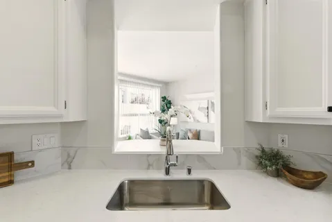 a kitchen with a sink and cabinets
