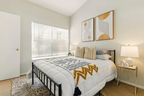 a bedroom with a bed and a window