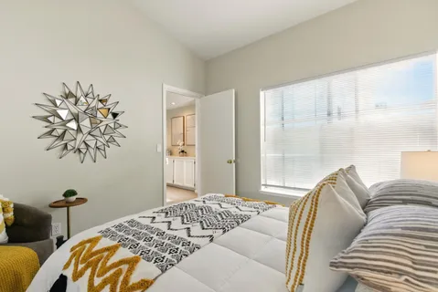 a bedroom with a bed and glass window