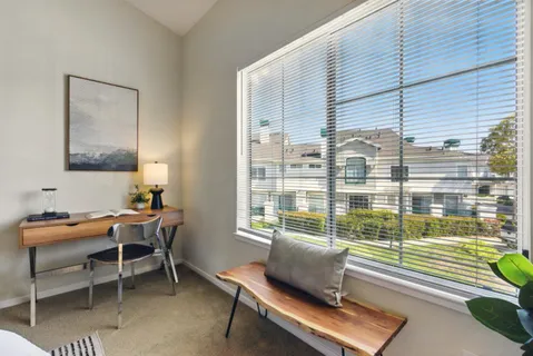 a reading room with furniture and a window