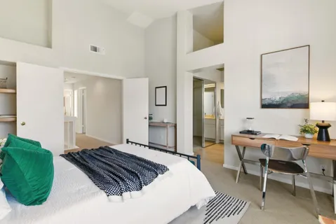 a bedroom with a bed and a chair