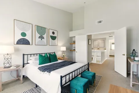 a bedroom with furniture and a wooden floor