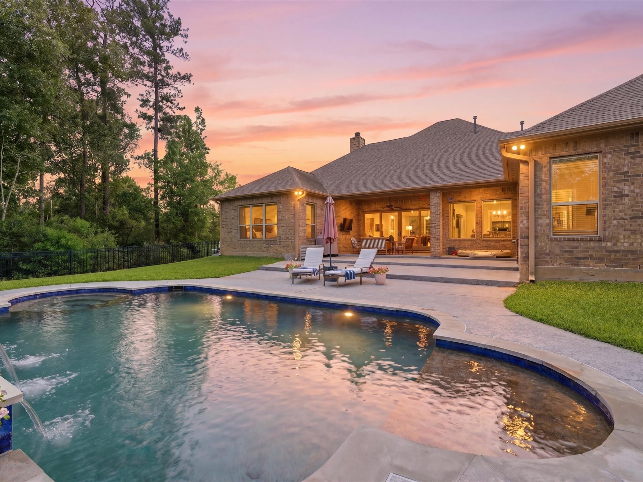 12618 Ranger Court Magnolia, TX 77354 - Photo 32 of 45 Step outside to an extended covered patio and sparkling pool, perfect for relaxing or hosting guests.
