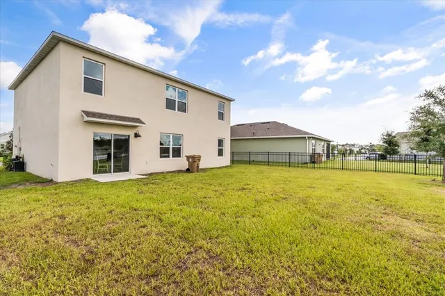 a house view with swimming pool and yard