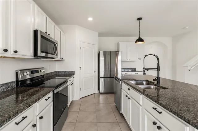 a kitchen with granite countertop stainless steel appliances and sink