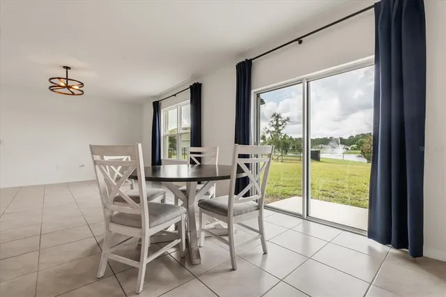a view of a dining room with furniture large windows and wooden floor