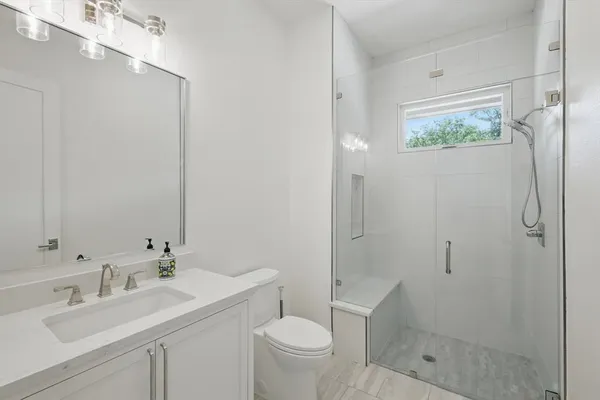 a bathroom with a sink toilet and shower