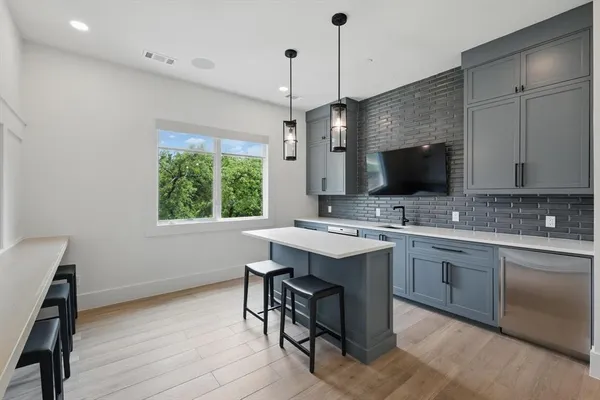 a kitchen with a sink appliances and a counter top space