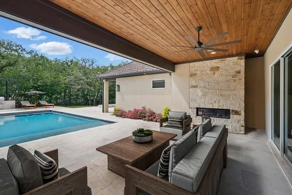 a view of a patio with table and chairs with wooden floor and fence
