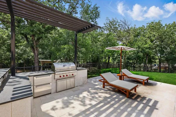 a sitting area with a bench and trees