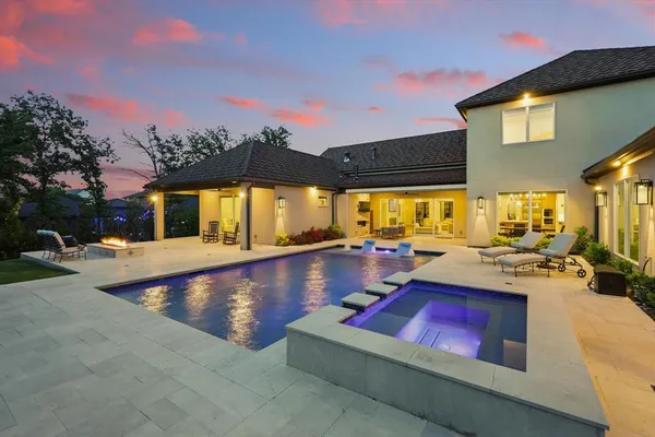 a view of swimming pool with outdoor seating and a potted plants