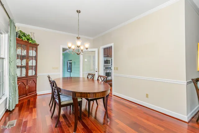 a view of a dining room with furniture and wooden floor