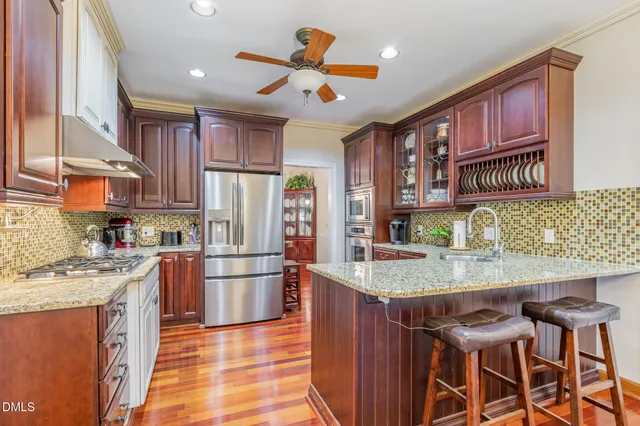 a kitchen with refrigerator cabinets and furniture