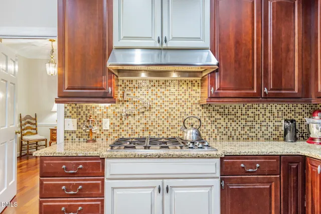 a kitchen with granite countertop cabinets and white appliances